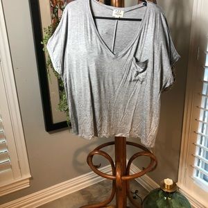 Very soft gray knit top. pocket embellishment.